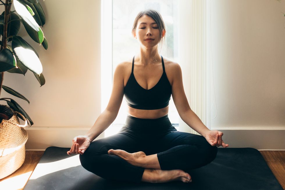 young woman meditating in a yoga pose