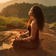 Young woman meditating on mountain top young woman meditating on mountain top