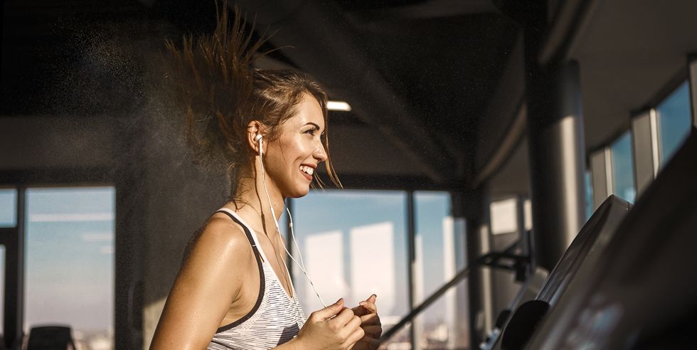young woman on treadmill exercise sweating