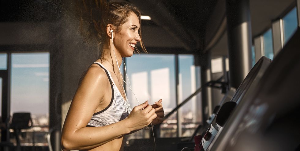 young woman on treadmill exercise sweating