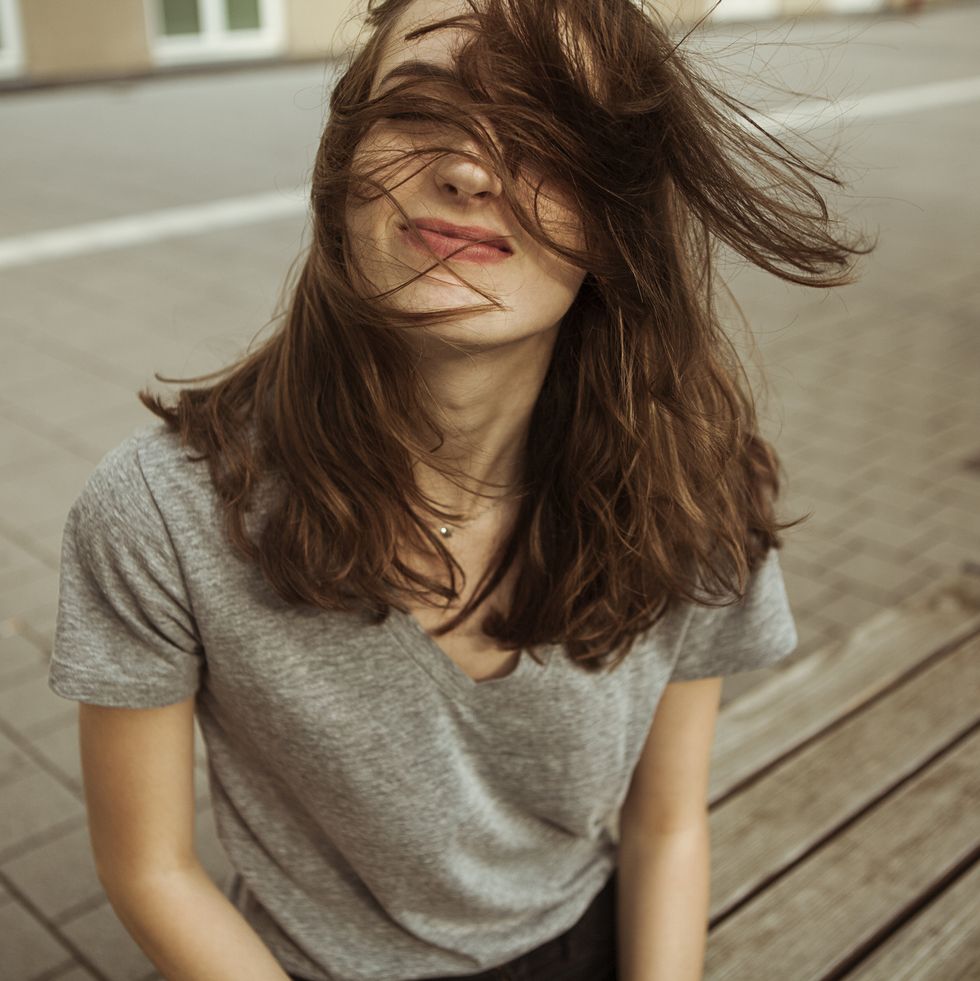 Young woman outdoors with windswept hair