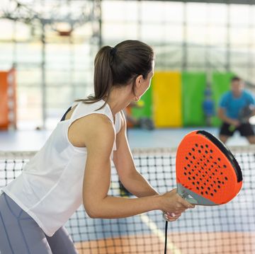 young woman playing paddle tennis