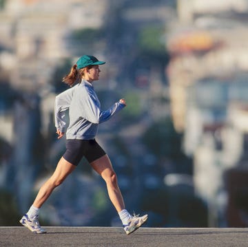 Young woman powerwalking in urban area, profile young woman powerwalking in urban area, profile
