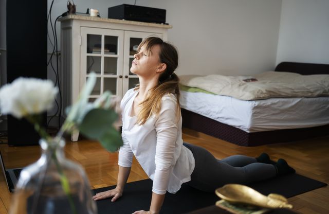 Young woman practice yoga at home