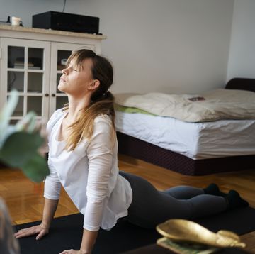 Young woman practice yoga at home
