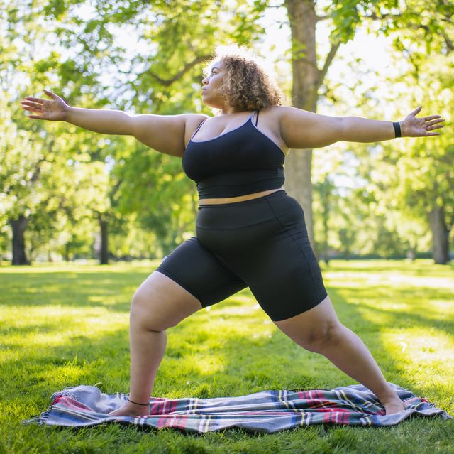 exercise and depression, young woman practicing yoga outdoors in park