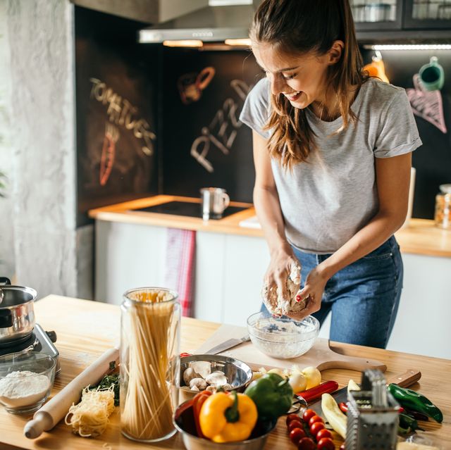 https://hips.hearstapps.com/hmg-prod/images/young-woman-preparing-pizza-royalty-free-image-1685733890.jpg?crop=0.668xw:1.00xh;0.133xw,0&resize=640:*