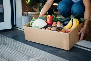 young woman receiving fresh food home delivery