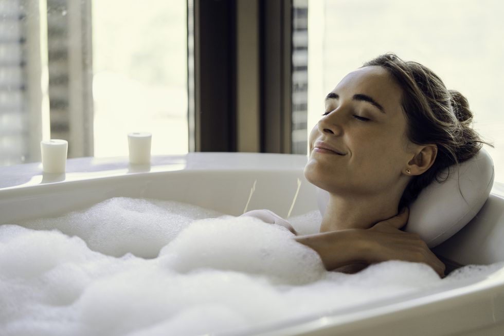 young woman relaxing in bathtub