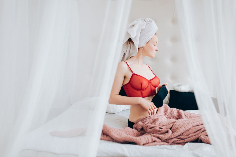 young woman relaxing in bed after shower