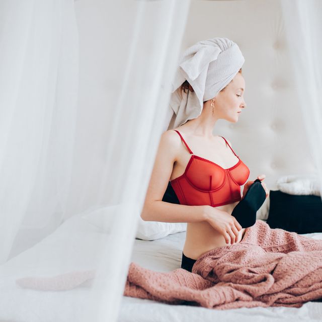 young woman relaxing in bed after shower