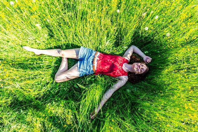 Young woman relaxing in meadow