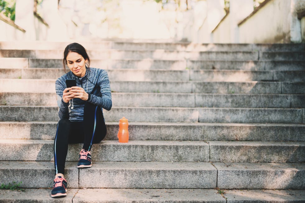 young woman resting after jogging in the park