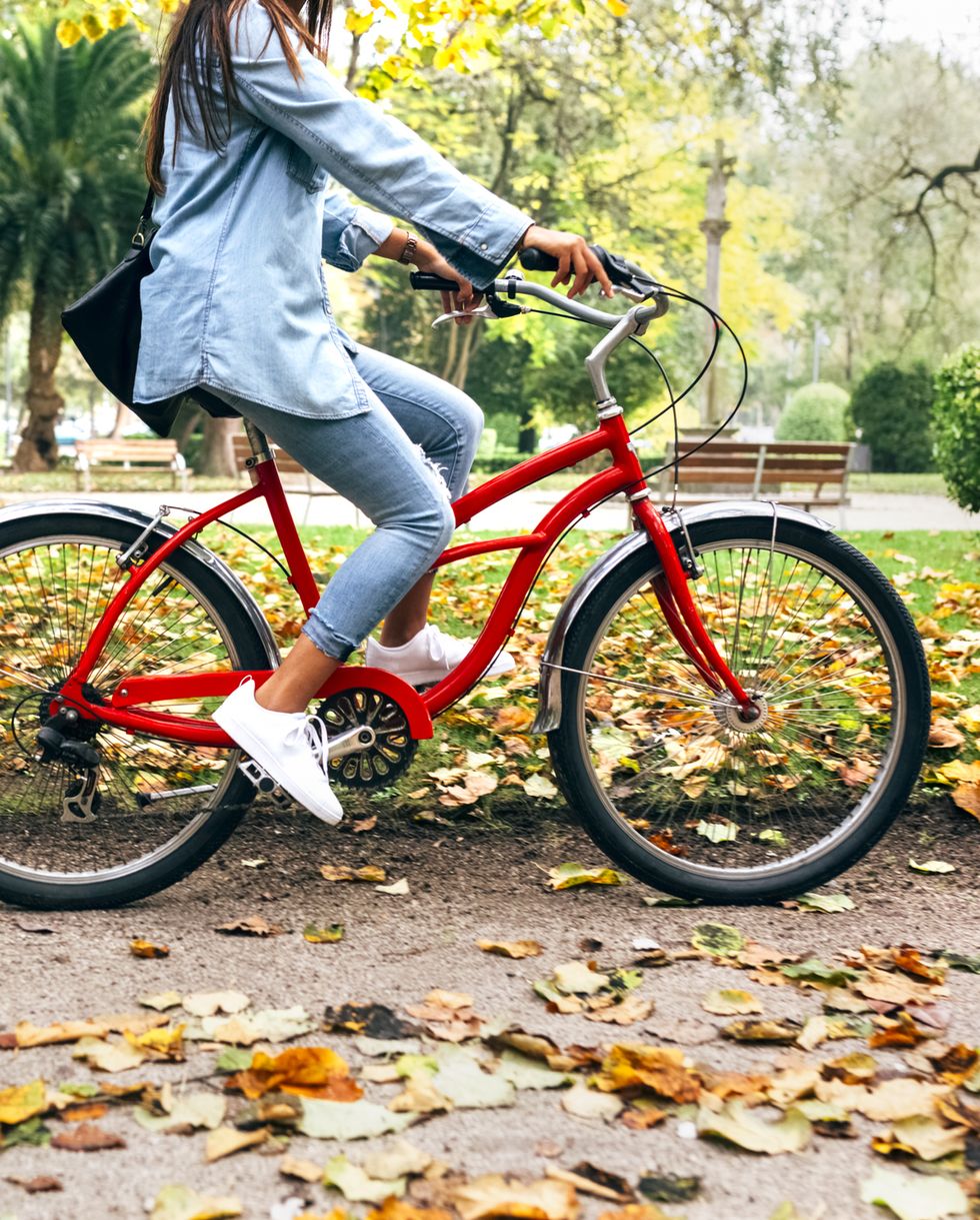 Young woman riding a bike in a park