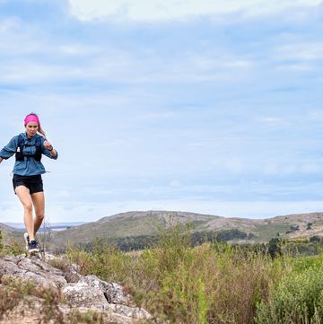 young woman running a race in the mountains