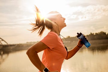 young woman running against morning sun