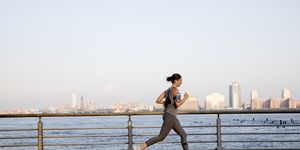 young woman running along hudson river