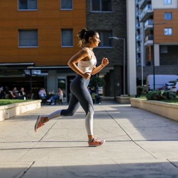 young woman running and warming up before training outdoors