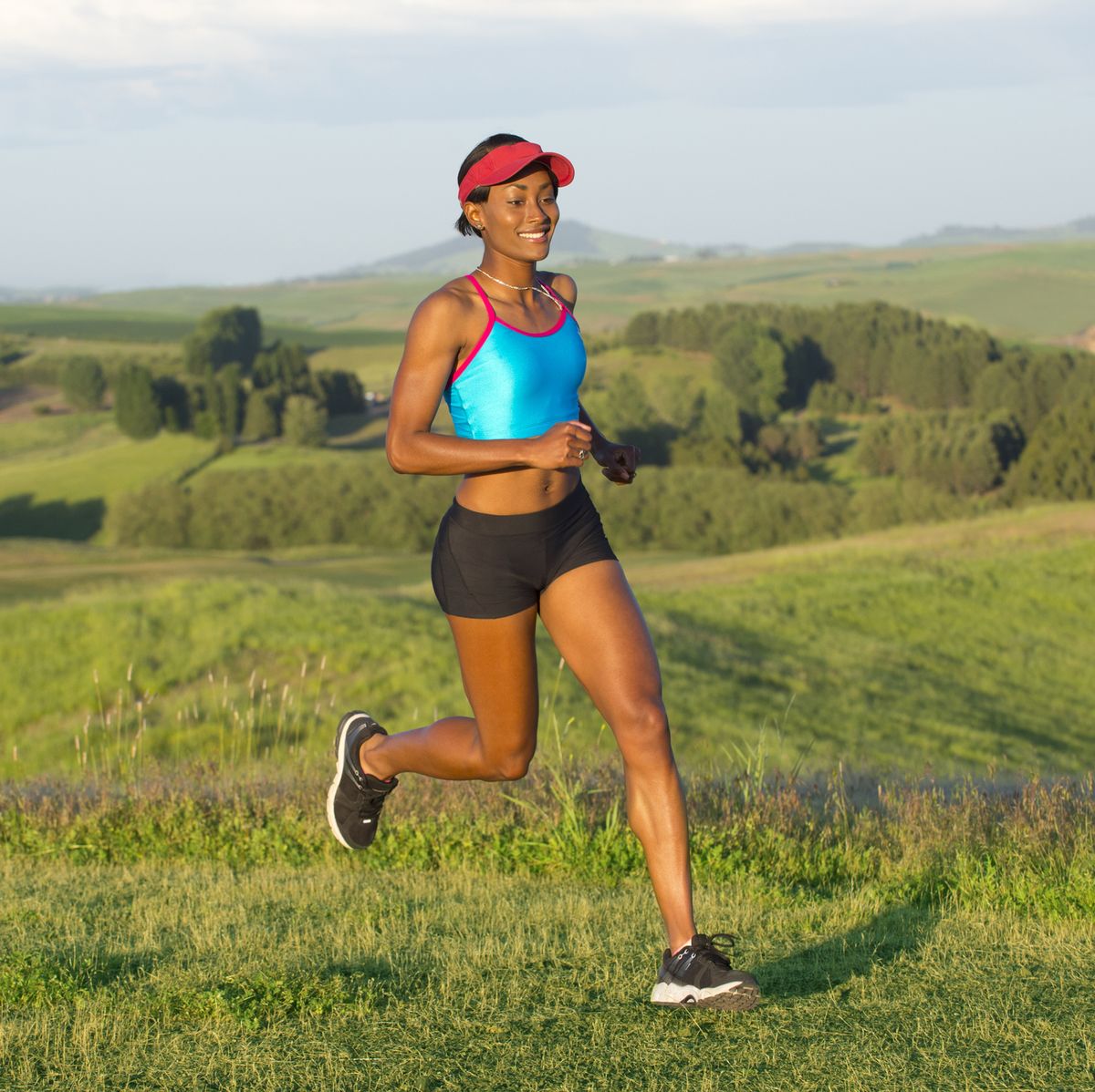 Young woman running in landscape, Othello, Washington, USA