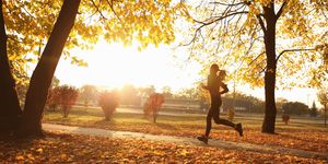 young woman running in park, autumn