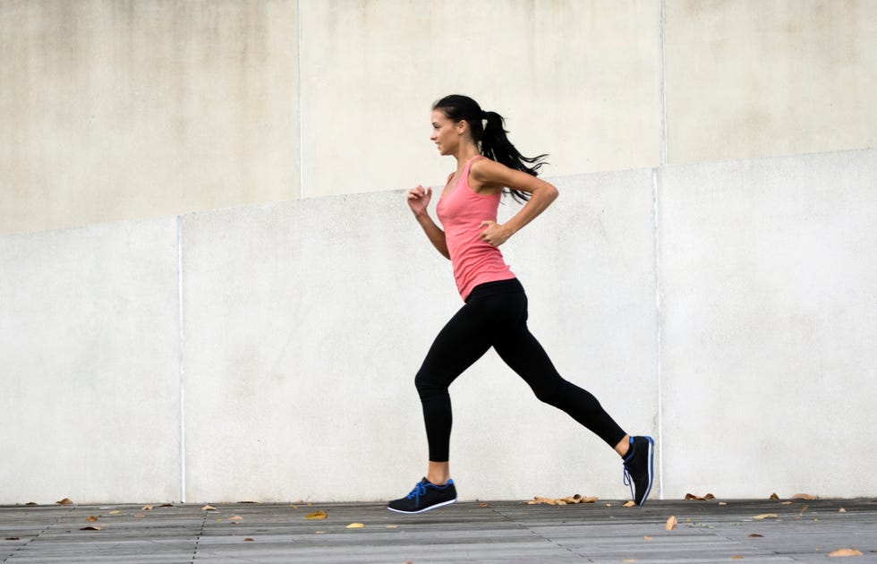 Young woman running in urban setting