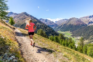 young woman running on a mountain path