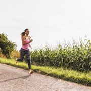 Young woman running on country lane