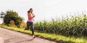 Young woman running on country lane