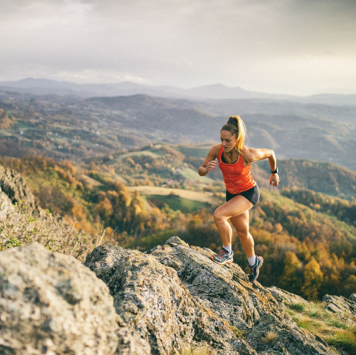 young woman running on mountain