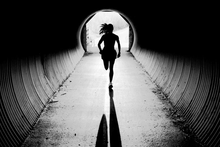 A young woman runs through a tunnel while training in Jackson, Wyoming.