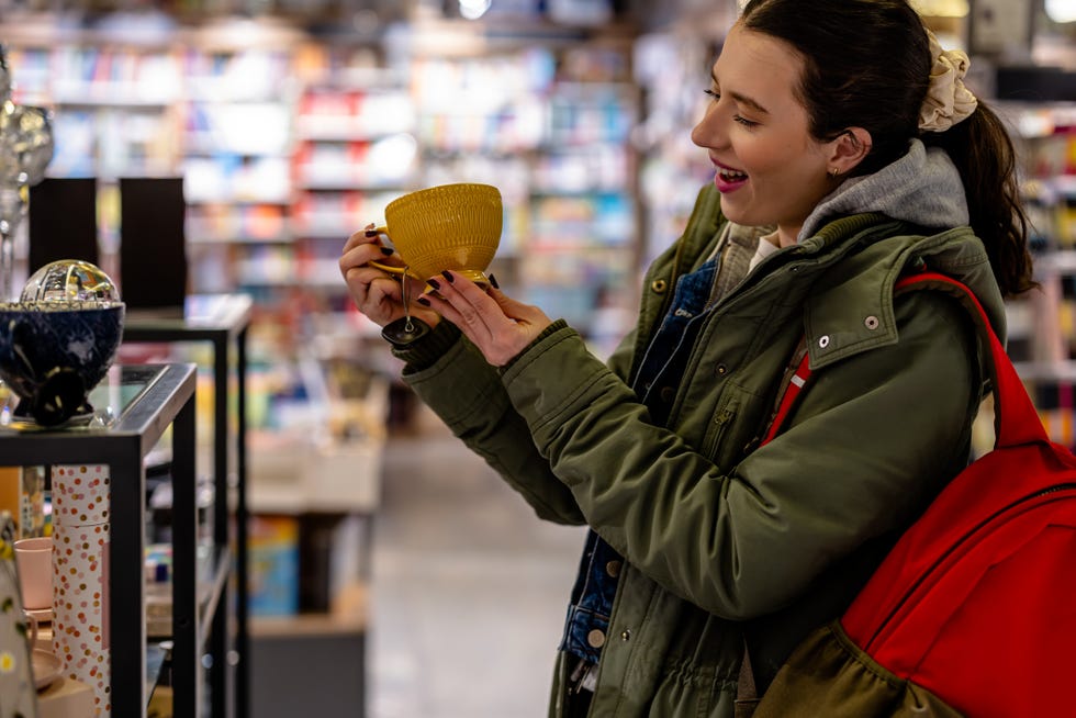 young woman selects cups to suit her daily emotions