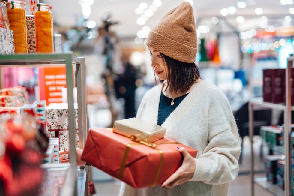 young woman shopping christmas gifts in department store