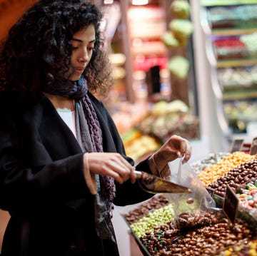 Young woman shopping in turkish delight shop in Grand Bazaar, Istanbul, Turkey young woman shopping in turkish delight shop in grand bazaar, istanbul, turkey