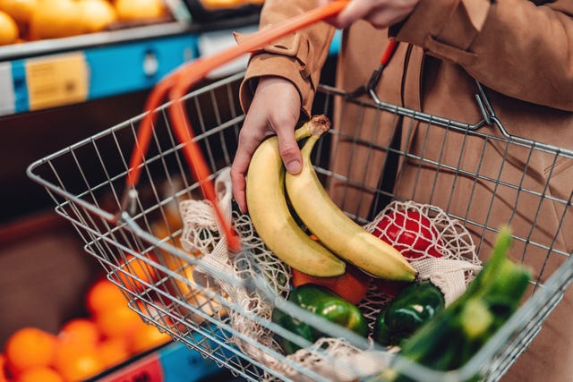 vrouw legt bananen in mandje