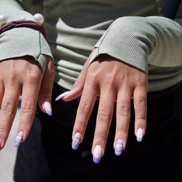 young woman showing her manicure, purple nail polish, hearts