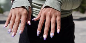 young woman showing her manicure, purple nail polish, hearts