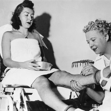 young woman getting hair removal in new york 1938