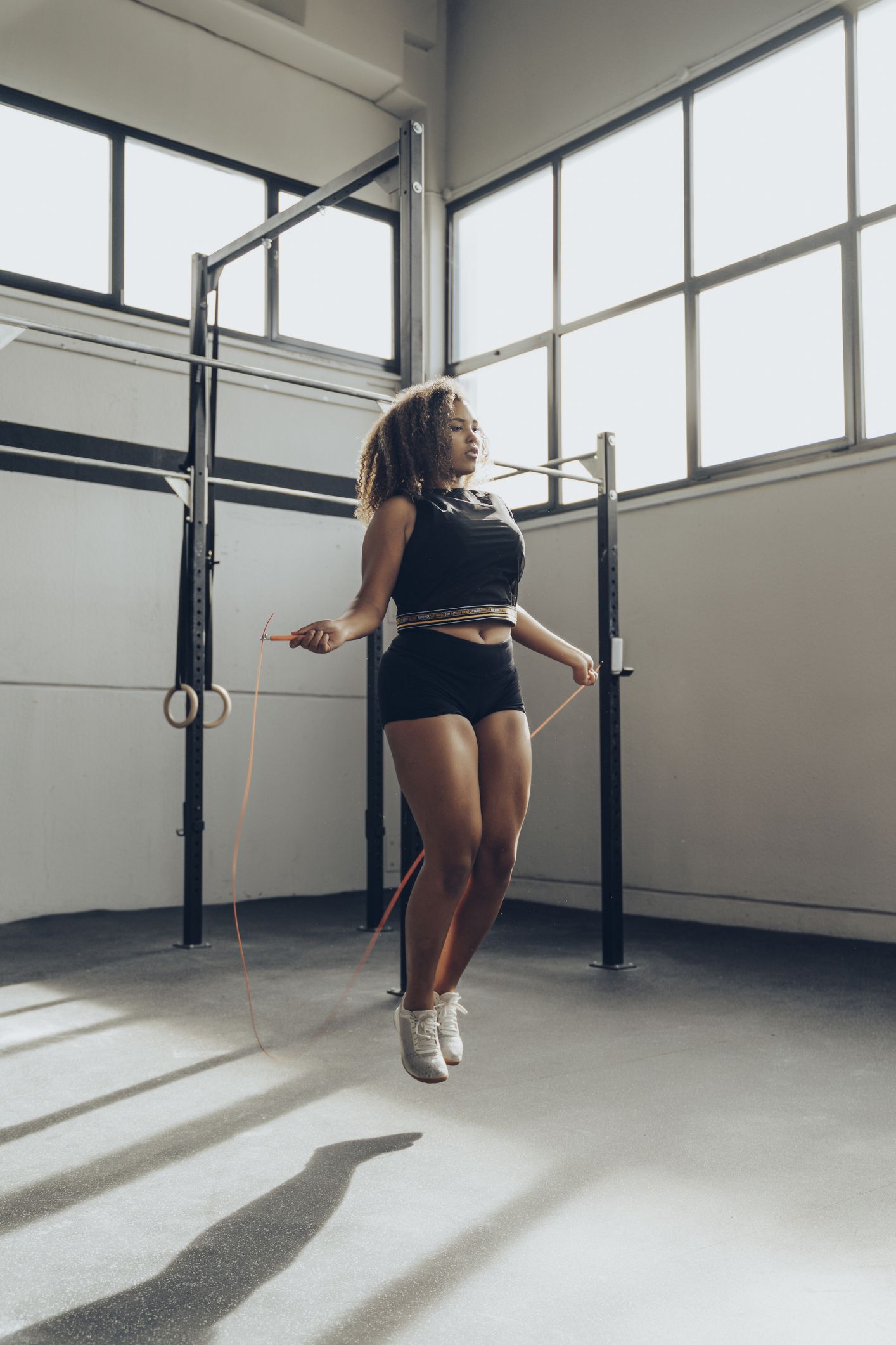 https://hips.hearstapps.com/hmg-prod/images/young-woman-skipping-rope-in-gym-royalty-free-image-1692362300.jpg