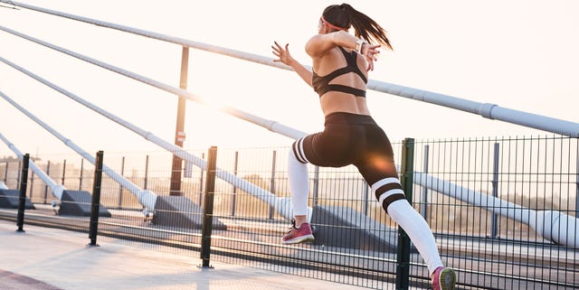 Young woman sprinting in the city