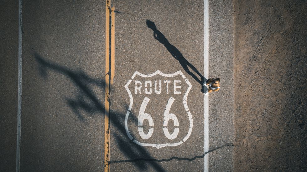 young woman stands on route 66