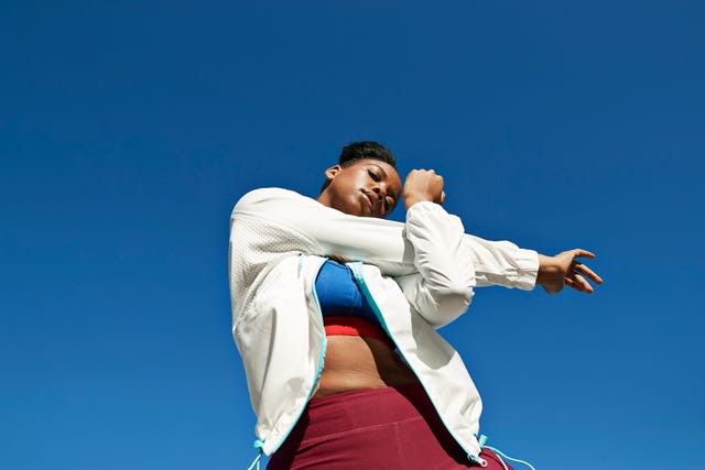 https://hips.hearstapps.com/hmg-prod/images/young-woman-stretching-arm-against-clear-blue-sky-royalty-free-image-1731944449.jpg?crop=1.00xw:0.752xh;0,0.154xh&resize=640:*