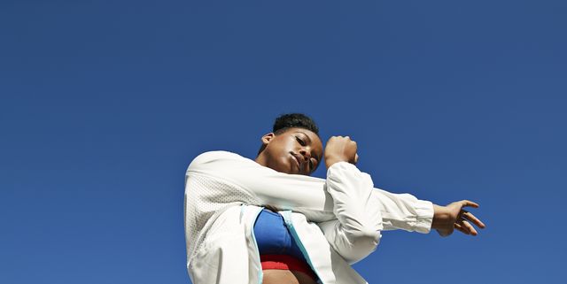 https://hips.hearstapps.com/hmg-prod/images/young-woman-stretching-arm-against-clear-blue-sky-royalty-free-image-1734036904.pjpeg?crop=1.00xw:0.752xh;0,0.248xh&resize=640:*