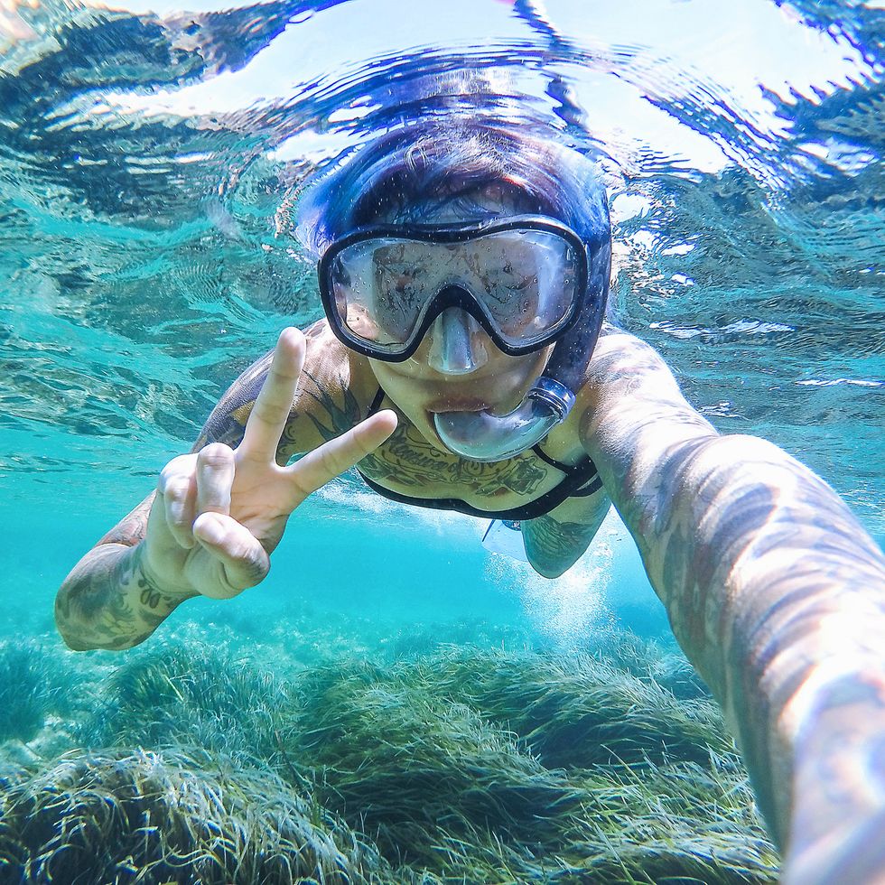 Young woman swimming with mask snorkeling