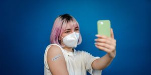 young woman taking a selfie after getting vaccinated