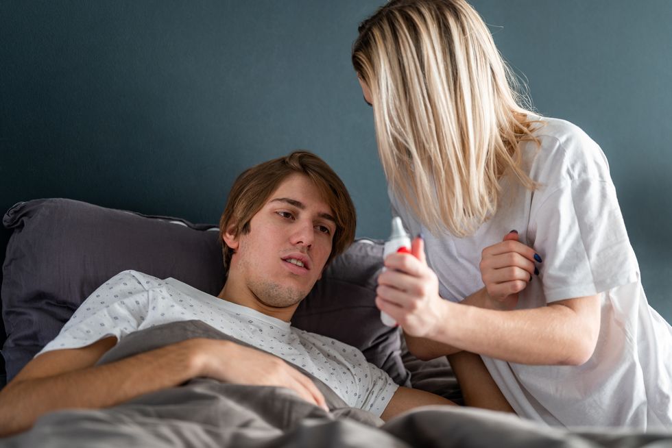 young woman taking care of a young sick man