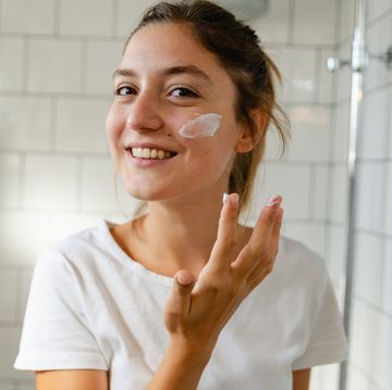 young woman taking care of her skin with a skin care routine