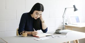 young woman taking notes in creative studio space