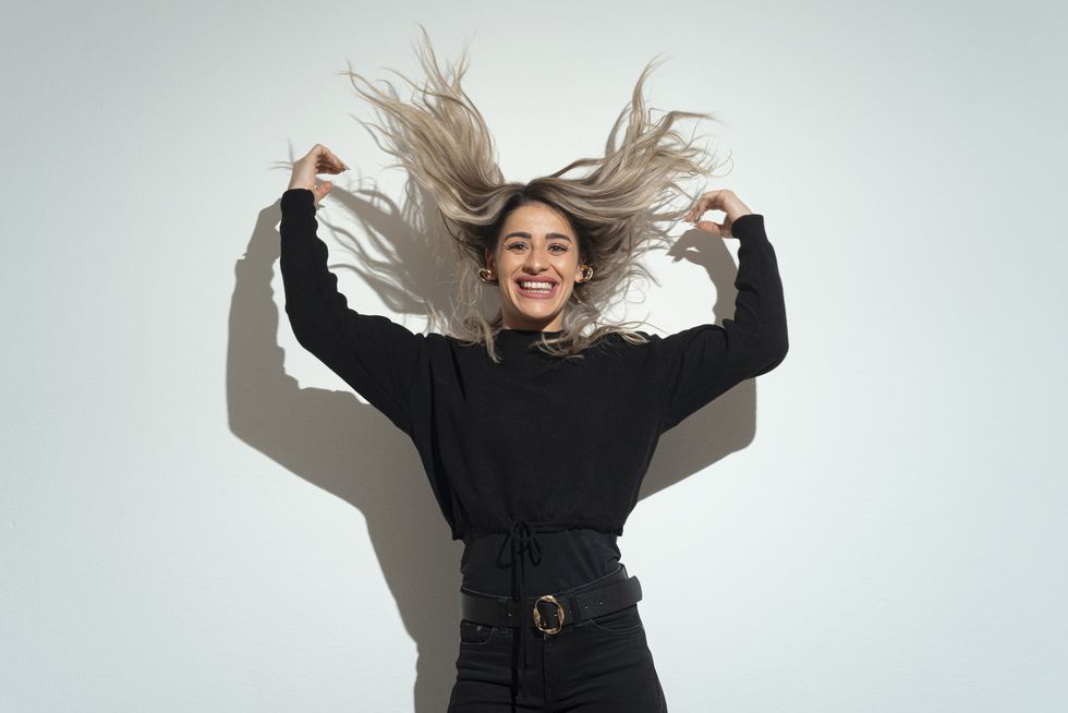 young woman tossing her flowing long hair
