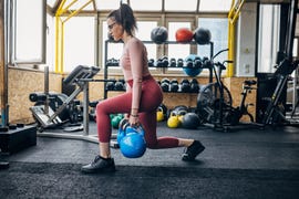 young woman training with kettlebells