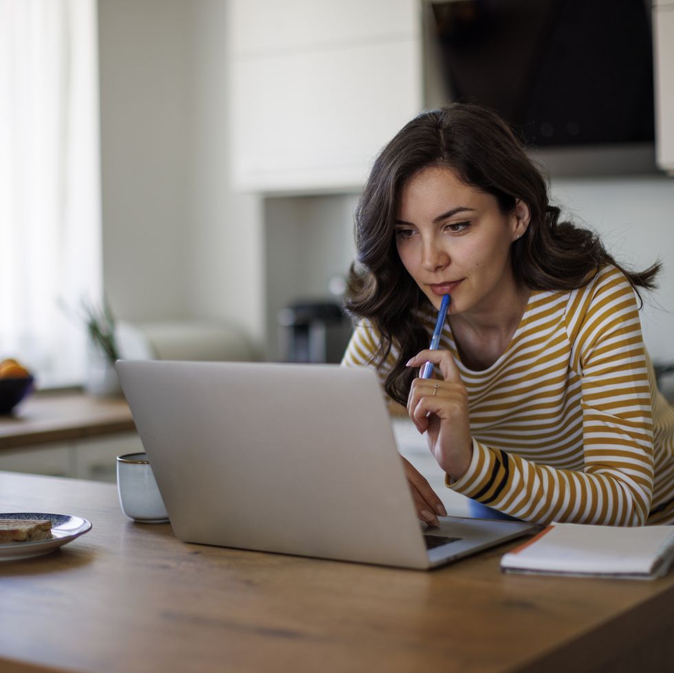 young woman using a laptop while working from home
